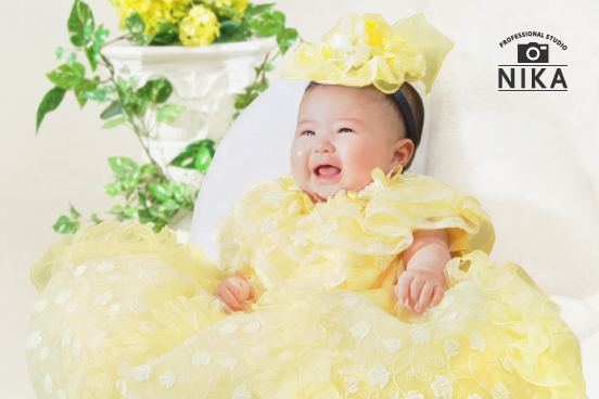 スタジオ二科で撮影された赤ちゃんの黄色いドレス姿の写真